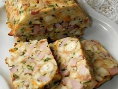 four slices of ham and cheese bread on a white plate next to a lace doily