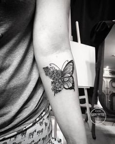 a woman with a butterfly tattoo on her arm