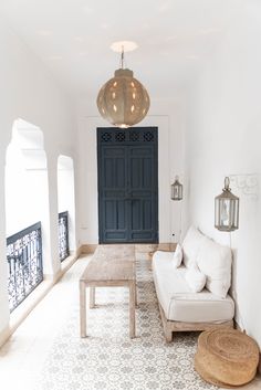 a living room filled with furniture and a large blue door