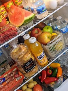 a refrigerator filled with lots of food and condiments on it's shelves