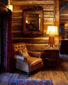 a chair and lamp in a room with wooden walls