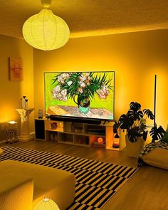 a living room filled with furniture and a flat screen tv on top of a wooden floor