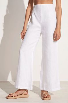 Discover our signature silhouette in the Ottavio Pants in White. Crafted from certified and responsibly sourced linen, these high-waisted linen pants are fitted through the waist and offer a flattering flare shape through the legs. This wardrobe essential is designed to be worn all year round and effortlessly styles with a linen crop top for a summer-ready look or an oversized long sleeve shirt to transition to the cooler months. High Waisted Linen Pants, Silk Cami Top, Oversized Long Sleeve Shirt, Linen Crop Top, White Linen Pants, Cropped Linen Pants, Striped Wide Leg Pants, Timeless Wardrobe Staples, Silk Cami