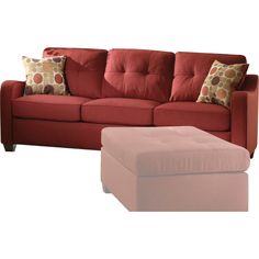 a red couch with pillows and a footstool