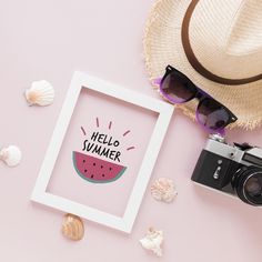 a watermelon slice with the words hello summer written on it next to a camera