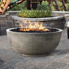 a fire pit sitting on top of a brick patio