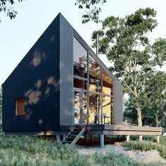 a house that is in the grass with stairs leading up to it's roof