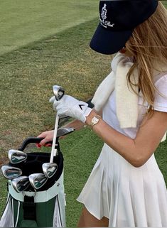 a woman in a white dress holding a golf club