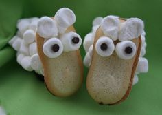 two little shoes with googly eyes on them sitting next to each other in front of a green cloth