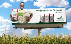 a billboard with an image of a man holding two bags of rice on top of it