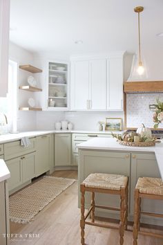 the kitchen is clean and ready to be used for cooking or baking, with two stools in front of the island