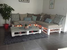 a living room with two couches and a coffee table on the floor next to a potted plant