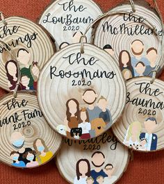 six personalized family ornament hangings on a wall in front of a red background