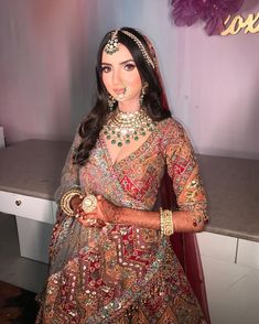 a woman in a bridal outfit posing for the camera