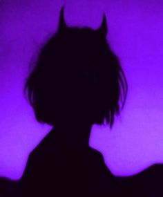 the silhouette of a person with horns on their head is shown in front of a purple background