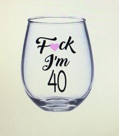 a wine glass with the words f k im 50 printed on it