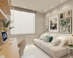 a living room filled with white furniture and pictures on the wall above it's windows