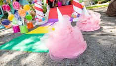 there are many candy cones on the ground and one has pink tulle in it