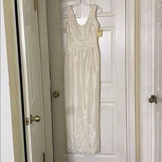 a white dress hanging on a door