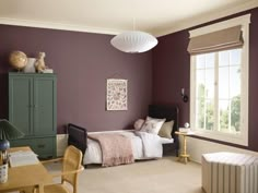 a bedroom with purple walls and white bedding