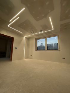 an empty room with three windows and no curtains on the ceiling is lit by recessed lighting