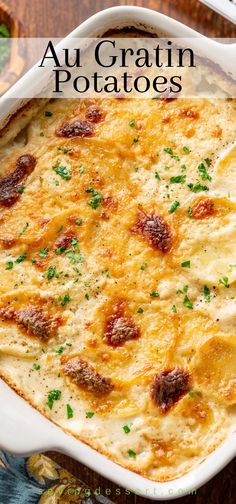 a casserole dish with cheese, meat and parsley in it on a wooden table