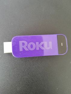 a purple sticker with the word roku on it sitting on top of a table