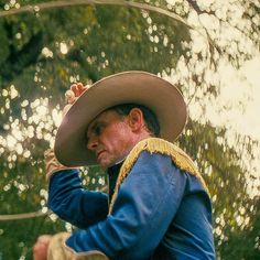 a man wearing a hat and blue jacket