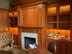 a living room filled with furniture and a fire place next to a bookcase full of books