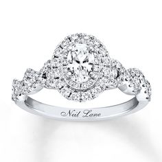 a diamond engagement ring with the name neil lane on it's side and an oval halo