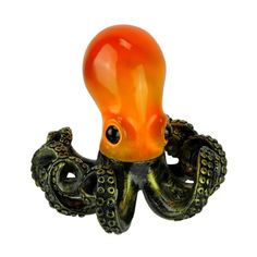 an orange and black octopus figurine on a white background