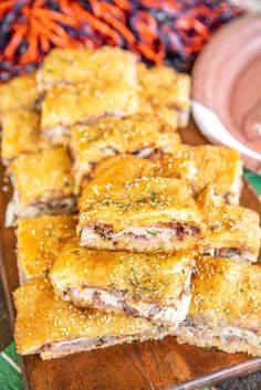 baked crescent sandwiches on a wooden cutting board with carrots in the background and text overlay