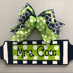 a door hanger with a green and white polka dot bow