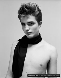 a shirtless young man wearing a black scarf around his neck is posing for the camera