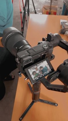 a camera sitting on top of a wooden table