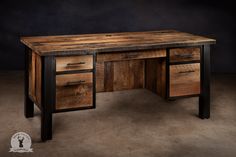 a desk made out of wood and metal with two drawers on each side, in front of a dark background