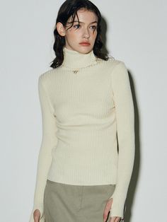 This is a turtleneck warmer top that creates a slim yet natural fit. It features an embroidered N logo of Nick&Nicole on the front.- Cropped length that makes your look stylish- Sleeve finger hole details for a hand warmer effect- Made from soft and stretchy yarn, providing a comfortable wear Winter White Turtleneck Tops For Fall, Elegant Winter White Turtleneck Top, Classic Turtleneck Top In Winter White, Classic Winter White Turtleneck Top, Cream Turtleneck Top With Ribbed Collar, Cream Turtleneck Tops With Ribbed Collar, Winter White Turtleneck Top For Layering, Winter White Stretch Turtleneck Top, Beige Turtleneck Top With Ribbed Collar