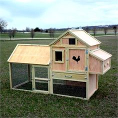 a chicken coop in the middle of a field