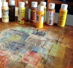 several different types of paint on a wooden table