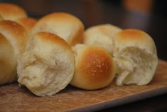 several rolls are sitting on a cutting board