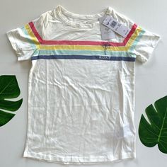 Fabric: Pure Cotton Jersey Fabric Fit: Classic, Comfortable Regular Fit Printed Multi-Colored Stripes With Roxy Print On Chest Playful White Top With Rainbow Print, Trendy White Top, Trendy White Top For Playwear, Fun White Top With Rainbow Print, Fun White Tops With Rainbow Print, Playful Cotton Tops With Rainbow Print, Playful Cotton Top With Rainbow Print, Casual Multicolor T-shirt For Playwear, Trendy Multicolor Tops For Playwear