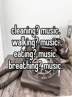 an old phone sitting on top of a wooden table with the words cleaning? music walking?