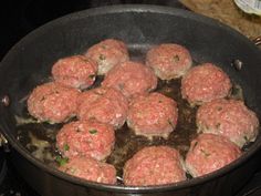 hamburger patties being cooked in a skillet on the stove with water and oil