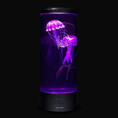 a purple jellyfish is glowing in the dark