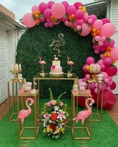 pink flamingo themed birthday party with cake and balloons on the side table, surrounded by lush green grass