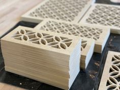 some cut out pieces of wood sitting on top of a wooden table next to each other