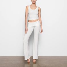 This soft, smooth, and stretchy ribbed pant features a throwback-inspired flare with a foldover waistband. Chic Flare Pants For Loungewear, Chic Elastane Sweatpants For Loungewear, Chic Flare Bottoms For Loungewear, Ribbed Flare Pants For Loungewear, Wide Leg 4-way Stretch Leggings For Loungewear, Flare Ribbed Pants For Loungewear, Chic Elastane Yoga Pants For Loungewear, Fitted Ribbed Yoga Pants For Loungewear, Ribbed Elastane Bottoms For Loungewear