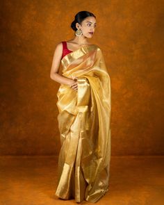 ABOUT THE SAREE Material :   Jute silk Blouse :  Jute silk Saree border : stone work with tassels Pallu : stone work with tassels Pico :  done Petticoat : can be procured for an extra cost Blouse length :  0.85 meters Saree length :  5.5 meters (6yards) Wash Instructions.  Dry cleaving only Flaunt your style without compromising on authenticity. Premium sarees for all occasions. What you'll get? Handmade work, carefully curated silk threads and detailed artistry.  Turn heads no matter what the o Slub Silk Pre-draped Saree With Zari Work For Puja, Gold Pre-draped Saree With Cutdana In Traditional Drape, Gold Pre-draped Dola Silk Saree With Dupatta, Festive Chanderi Pre-draped Saree For Celebration, Banarasi Silk Pre-draped Saree For Celebration, Gold Pre-draped Saree With Cutdana For Navratri, Navratri Celebration Pre-draped Saree With Zari Work, Festive Celebration Pre-draped Saree With Zari Weaving, Gold Raw Silk Pre-draped Saree For Festivals