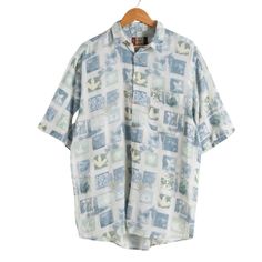 Printed woven shortsleeve shirt.  Size: Large (Marked as a Large, chest 102cm - 107cm).  Cotton. Summer Shirt With Short Sleeves And Pockets, Casual Short Sleeve Shirt For Summer, Short Sleeve Shirt With Pockets For Beach, Beach Shirt With Pockets And Short Sleeves, Vintage Cotton Hawaiian Shirt With Short Sleeves, Casual Patterned Short Sleeve Shirt For Vacation, White Short Sleeve Camp Shirt For Summer, Green Short Sleeve Summer Shirt, Spring Vacation Short Sleeve Shirt