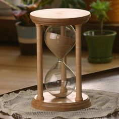 an hourglass sitting on top of a wooden table